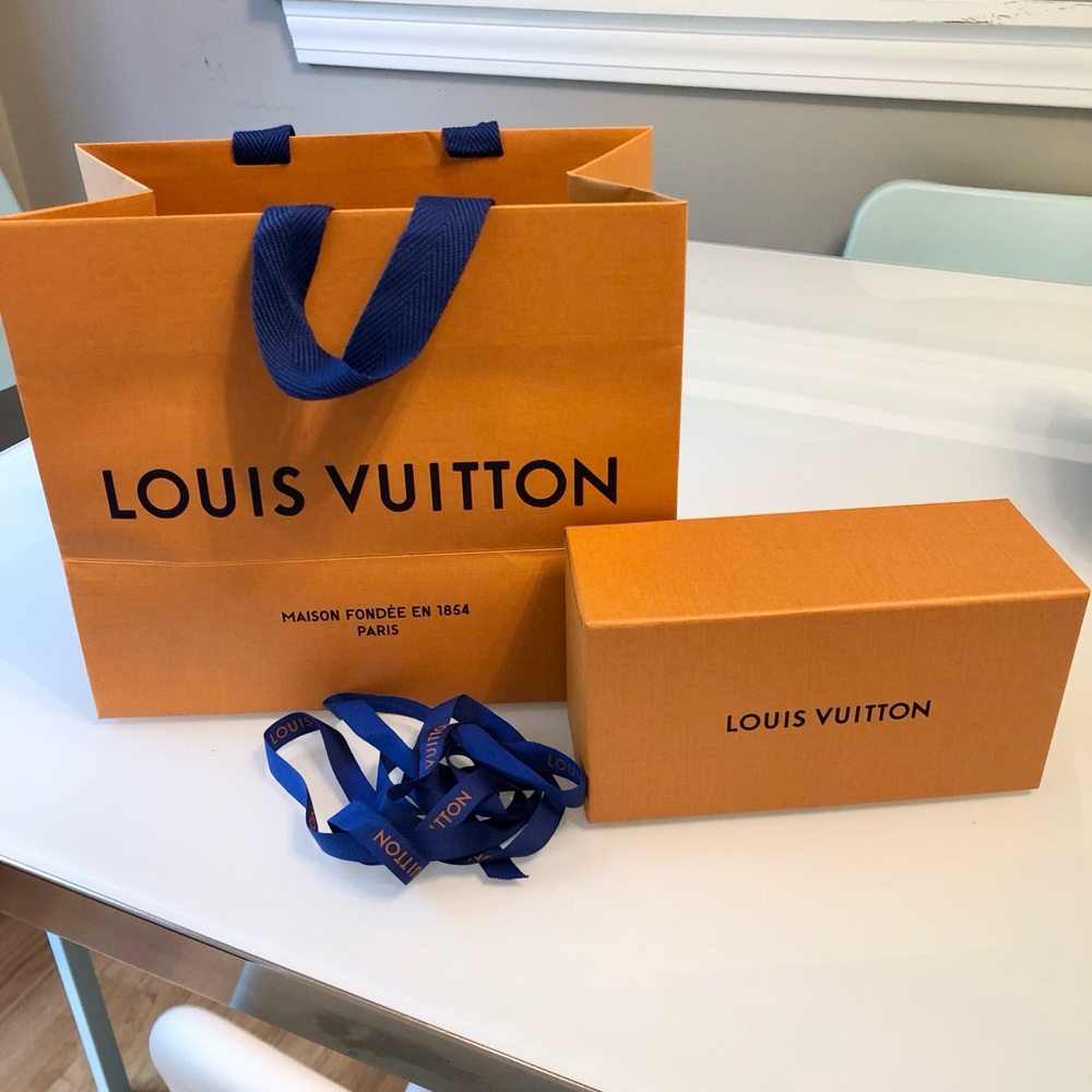 Empty Louis Vuitton box, bag, and ribbon
